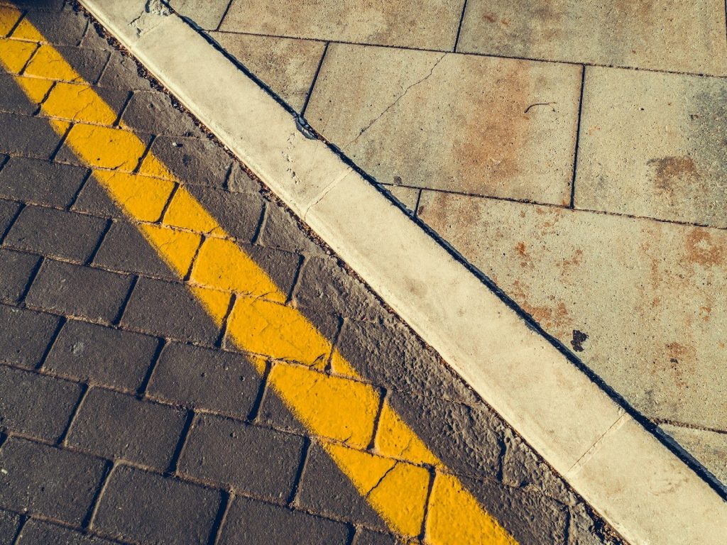 gray concrete pavement with yellow and white line