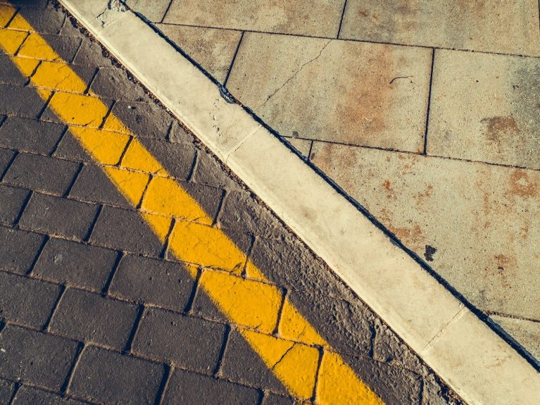 gray concrete pavement with yellow and white line