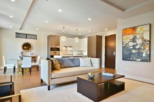 Modern, stylish living room with open concept kitchen.