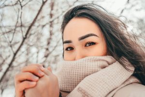 Photo by Tima Ilyasov a woman with a scarf around her neck