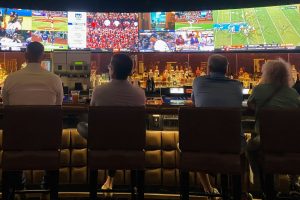 Photo by Amit Lahav a group of people sitting at a bar watching tv