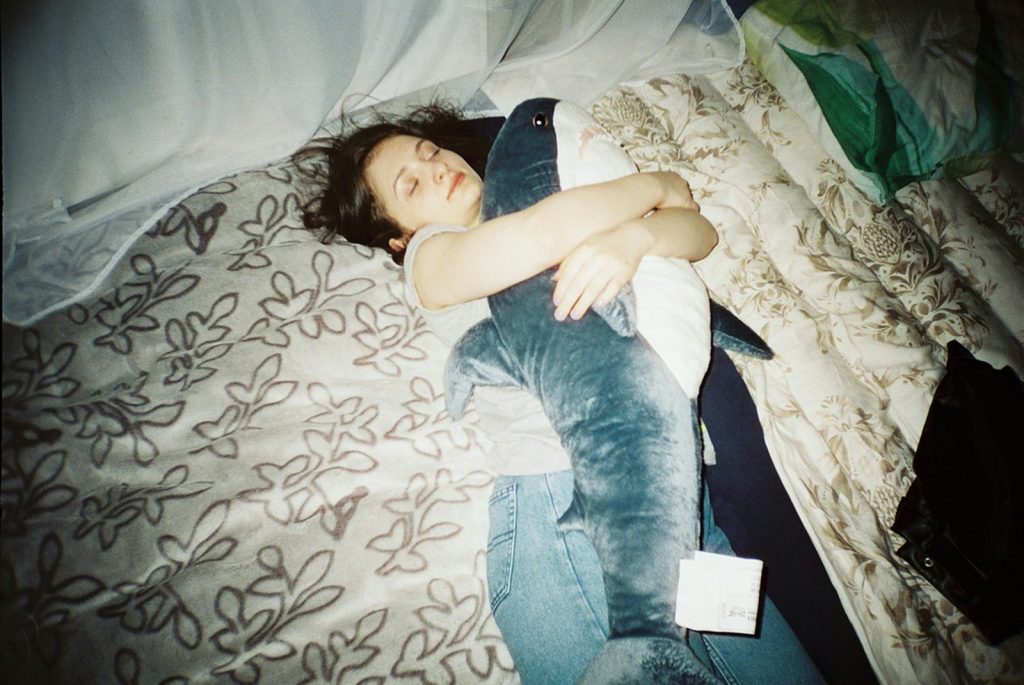 woman in blue denim jeans lying on bed