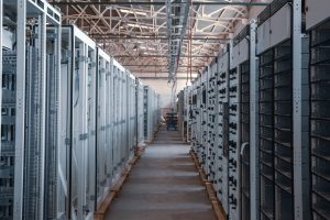 Photo by İsmail Enes Ayhan server room aisle with metal equipment racks