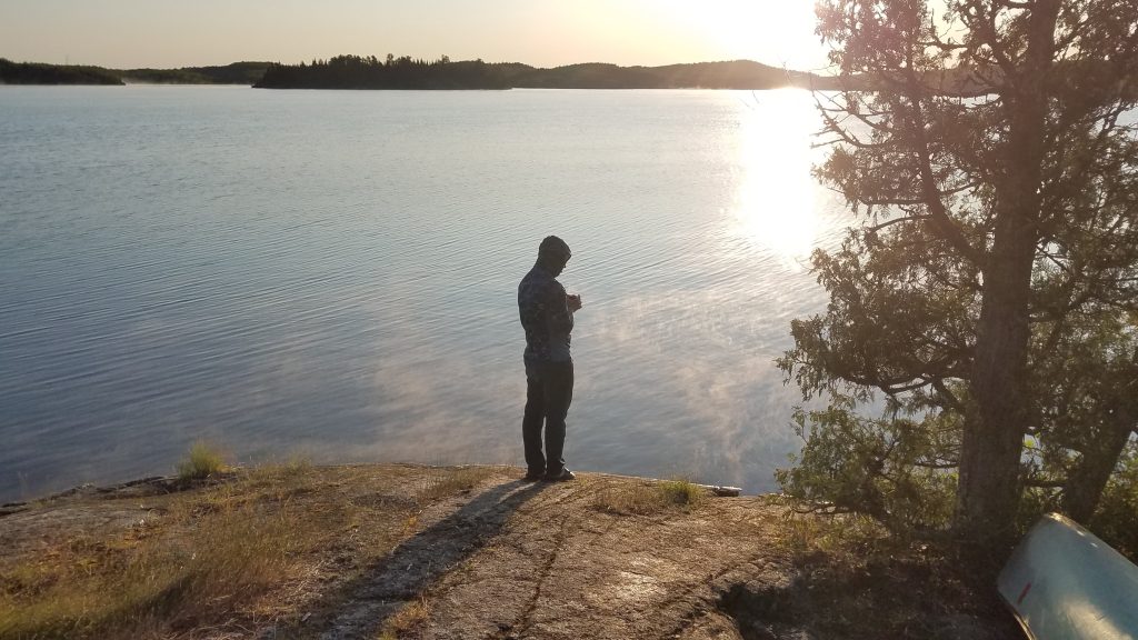 Camper by Lake with Coffee