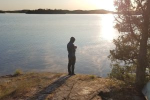 Camper by Lake with Coffee
