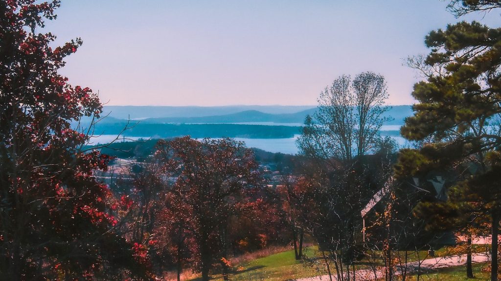 a scenic view of a lake and mountains in the distance