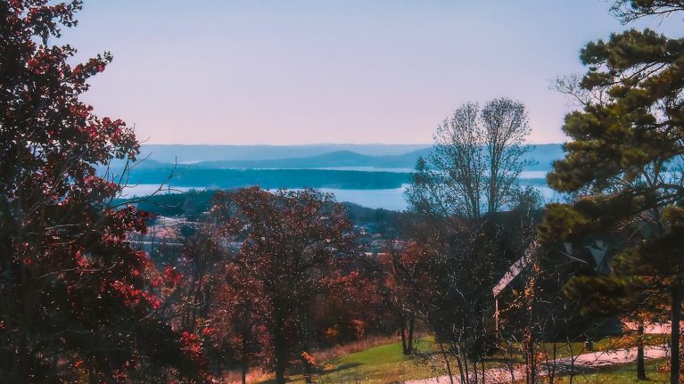 a scenic view of a lake and mountains in the distance